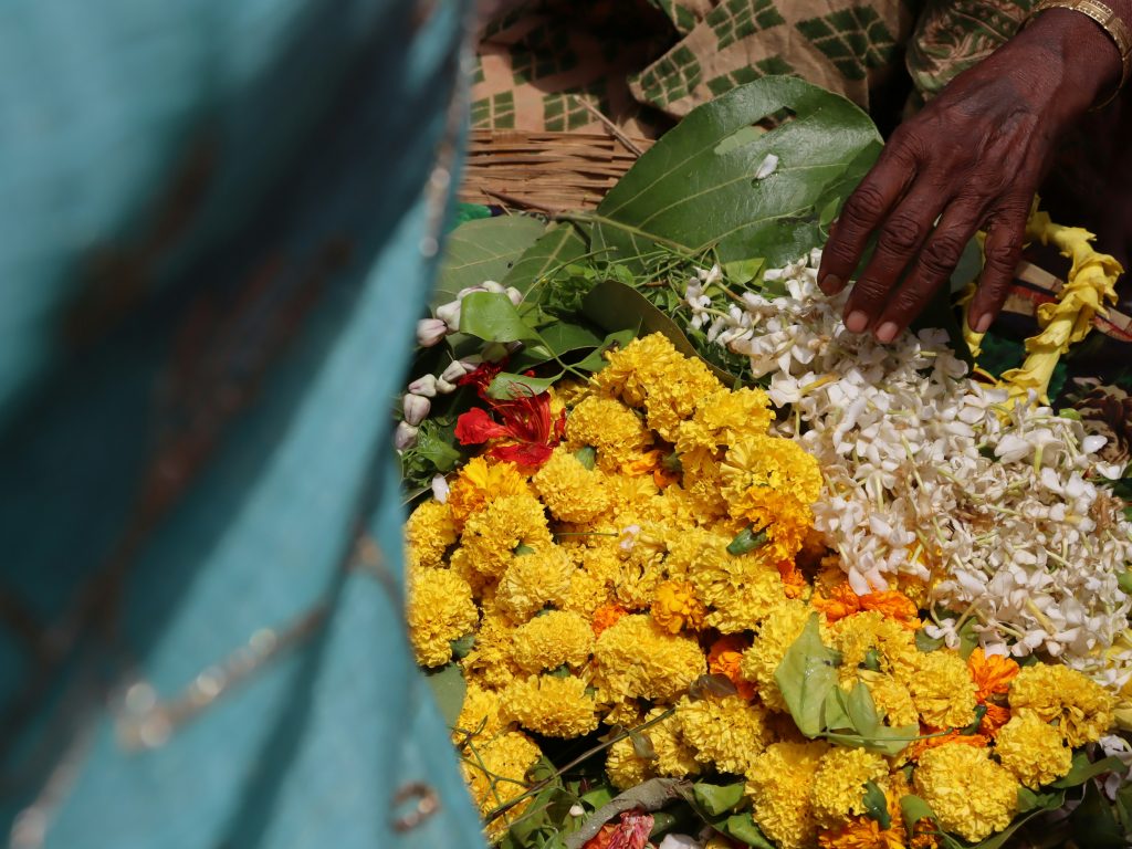 Woman holding a bouquet in a quiet, reflective moment