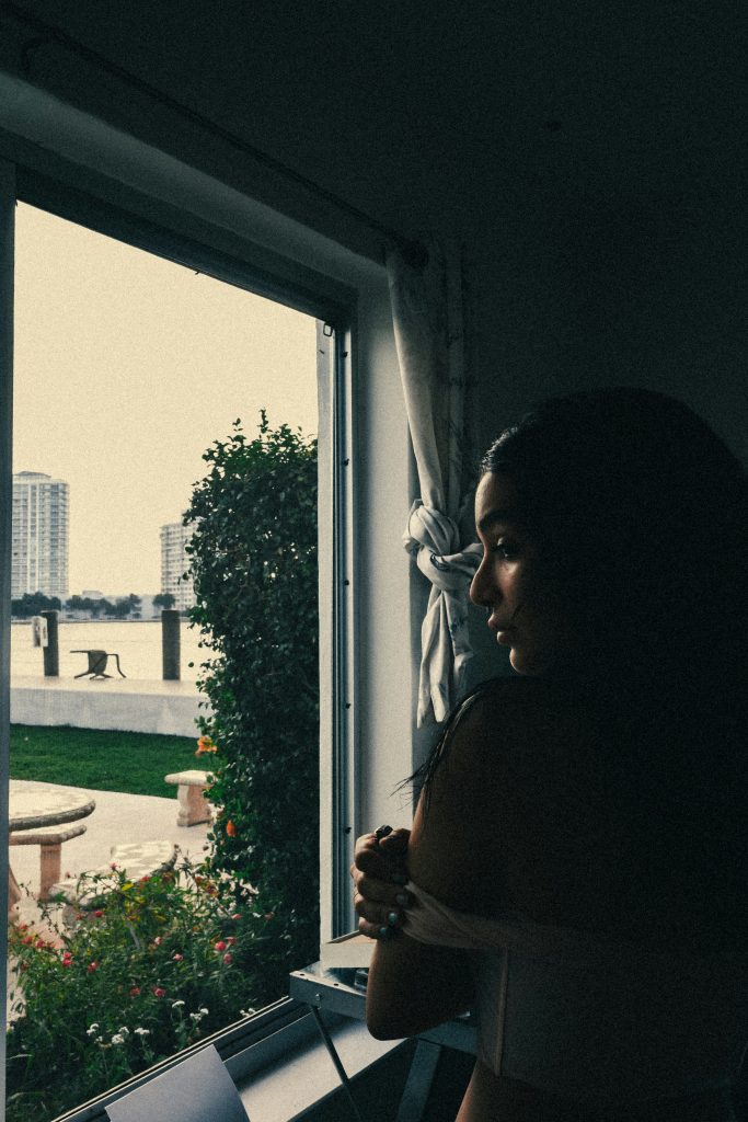 Sad woman alone reflecting after a failed relationship